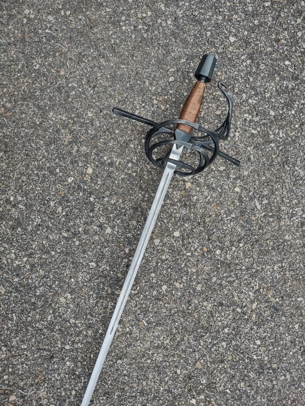 Left-handed, 3-ring spiral rapier with copper wrapped handle grip.